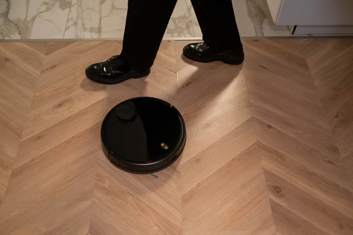 A multi-function docking station with automatic mop cleaning and heated air drying system, showing the base station's intelligent maintenance features