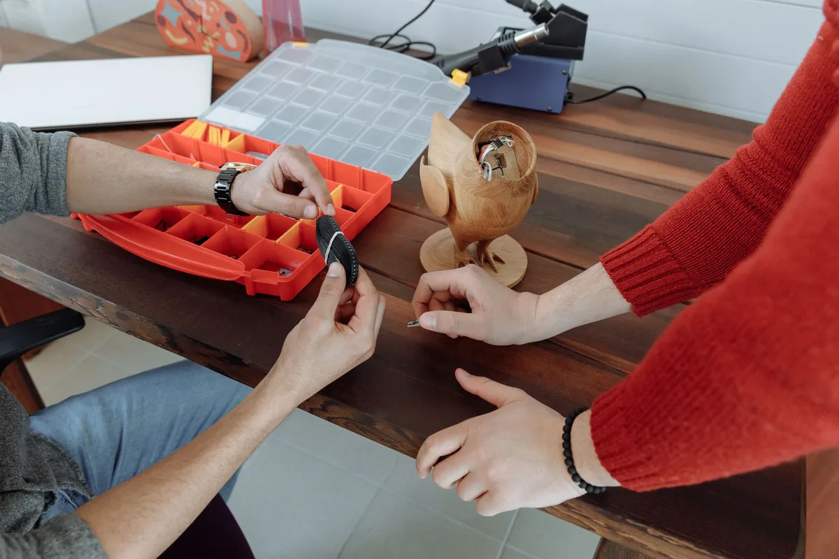 A modular smartphone with removable components arranged around it, emphasizing individual parts and internal architecture against a clean background