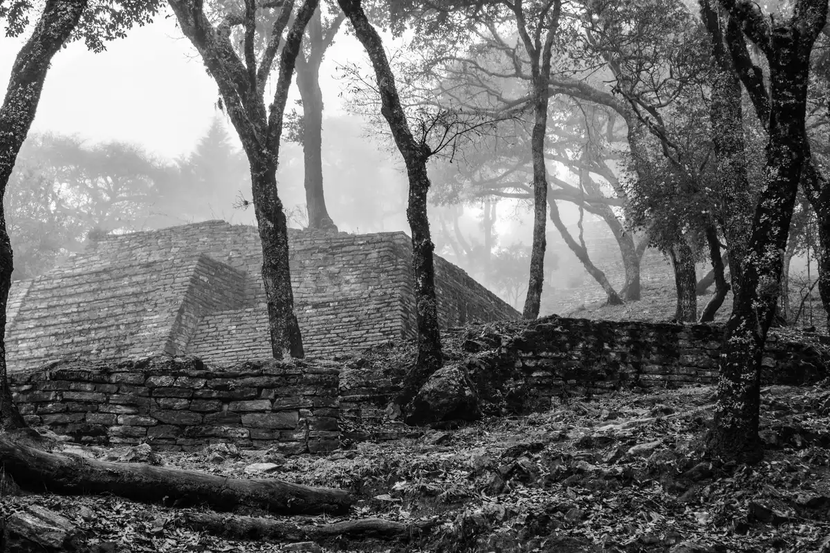 A fantasy landscape with ancient ruins shrouded in mist, evoking the decadence of fallen civilizations and the melancholic worlds of FromSoftware games.