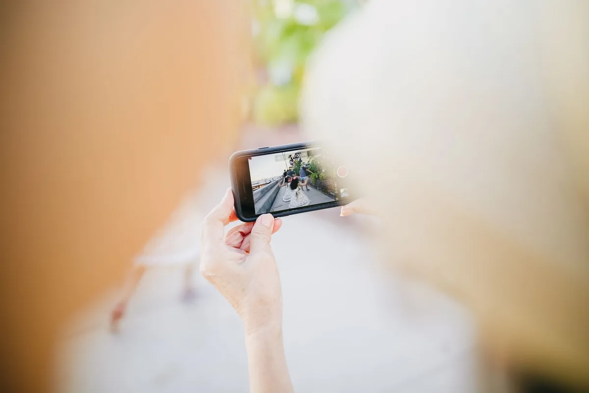 Smartphone display showing vibrant colors under bright sunlight, with visible text and icons, emphasizing screen brightness and outdoor visibility in daylight conditions.
