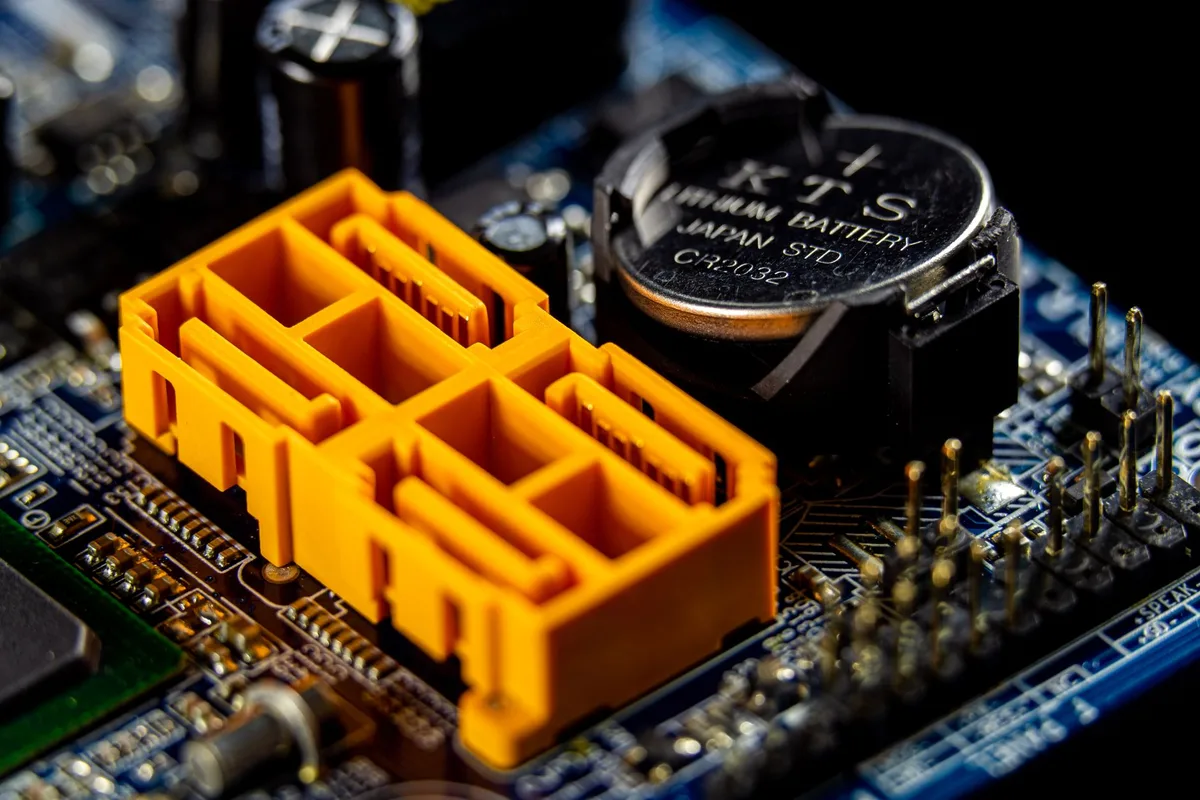 Close-up of an unbranded circuit board with a small SoC chip and surrounding passive components, no logos visible