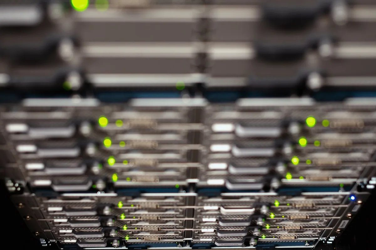 empty server rack with blinking status lights and an admin console in the foreground, anonymous, no logos