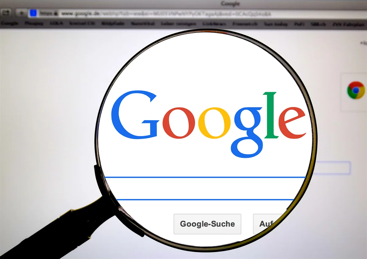 Close-up of anonymous hands using a laptop with a browser profile icon visible on the corner of the screen; no logos, no readable text